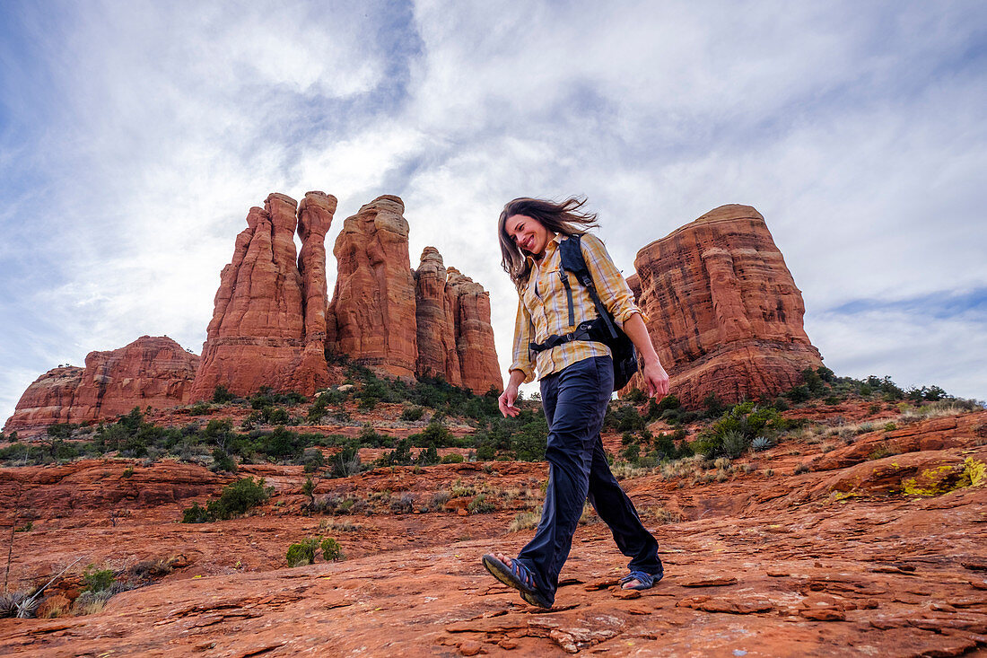 Female hiker walking down rocks at Cathedral Rock, Arizona, USA