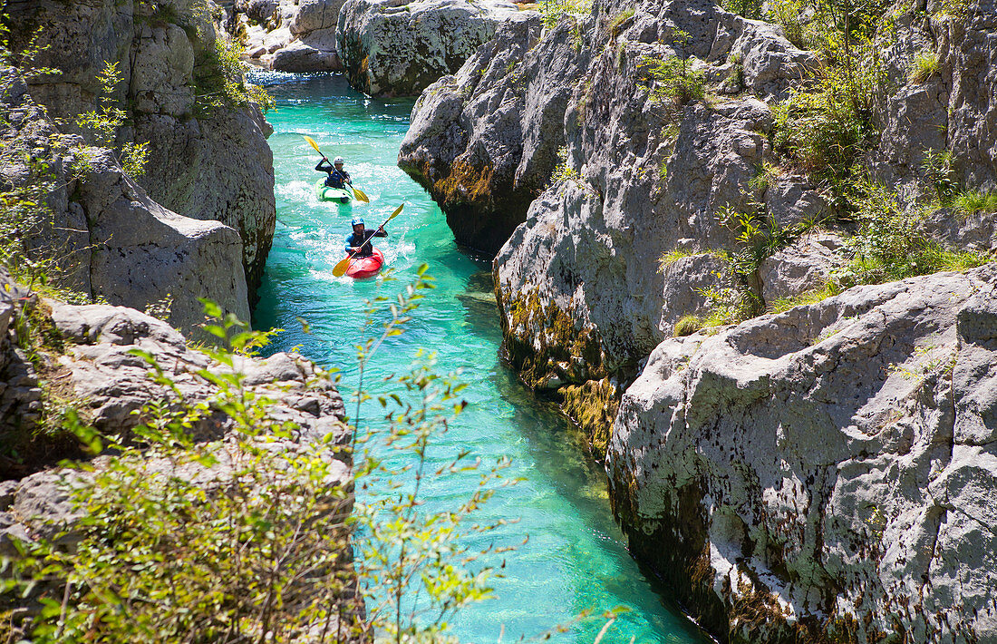Kayakkers on the emerald Soca near Bovec in Slovenia. This green colored river, originating in the Triglav mountains, is famous for all kinds of white water activities. 