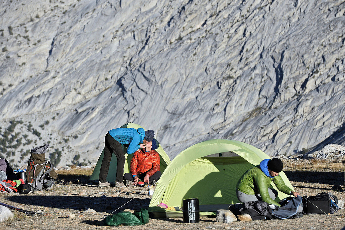 Backpackers break down camp and pack up in the Puppet Lake Basin on a two-week trek of the Sierra High Route in the John Muir Wilderness in California. The 200-mile route roughly parallels the popular John Muir Trail through the Sierra Nevada Range of California from Kings Canyon National Park to Yosemite National Park. 