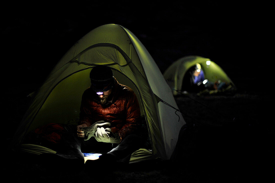 Backpackers use headlamps at night while camping near Thousand Island Lake on trek of Sierra High Route in Minarets Wilderness, Inyo National Forest, California, USA