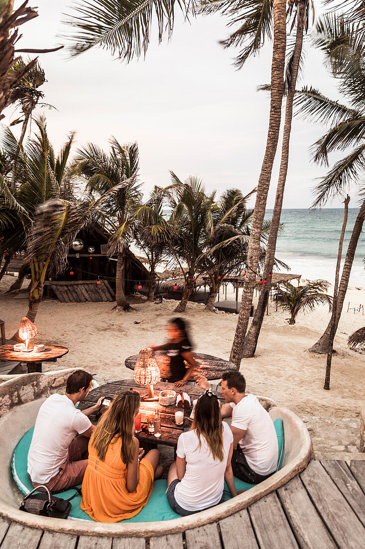People enjoying beach at Papaya Playa Resort in Tulum, Mexico