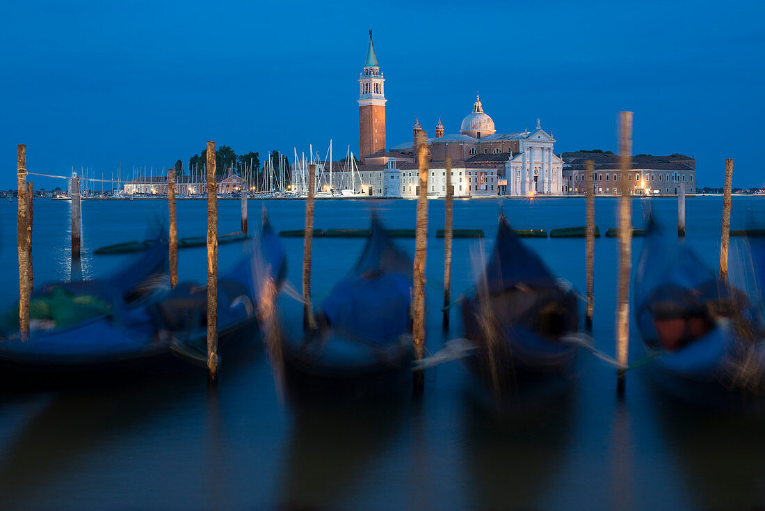 Gondolas near San Marco moored to wooden posts at twilight with San Giorgio in the distance, Venice, UNESCO World Heritage Site, Veneto, Italy, Europe