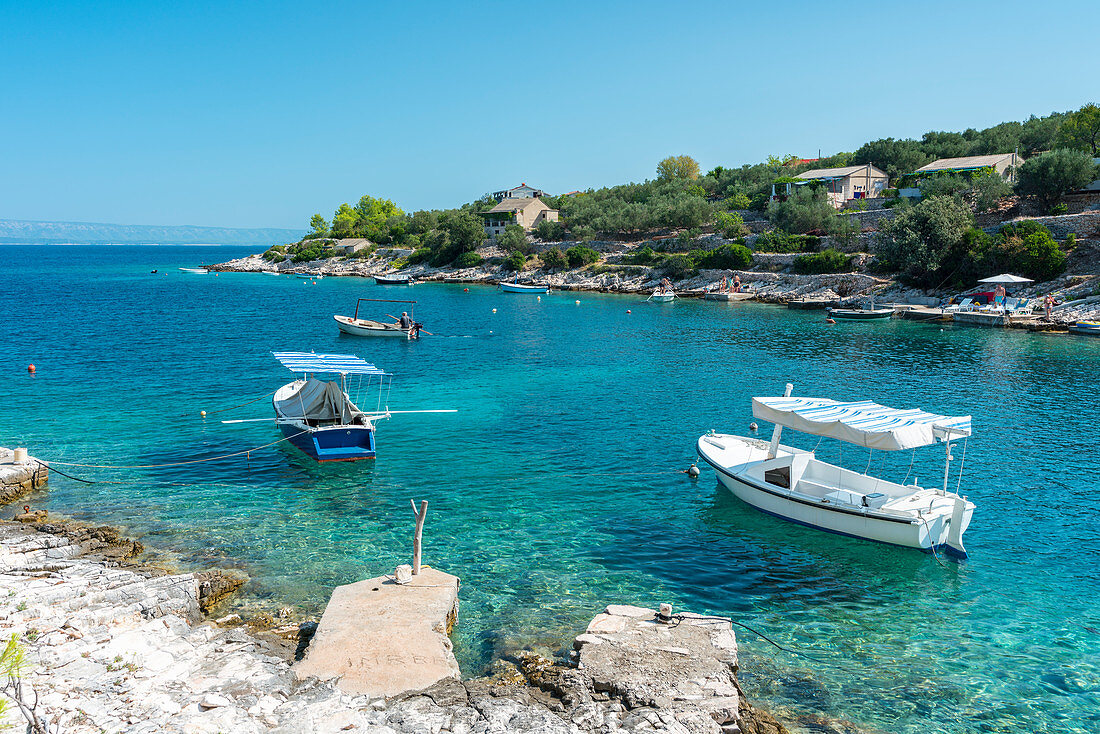 Boats at the little pier of Tankaraca cove in summer, Vela Luka, Korcula island, Dubrovnik-Neretva county, Croatia, Europe