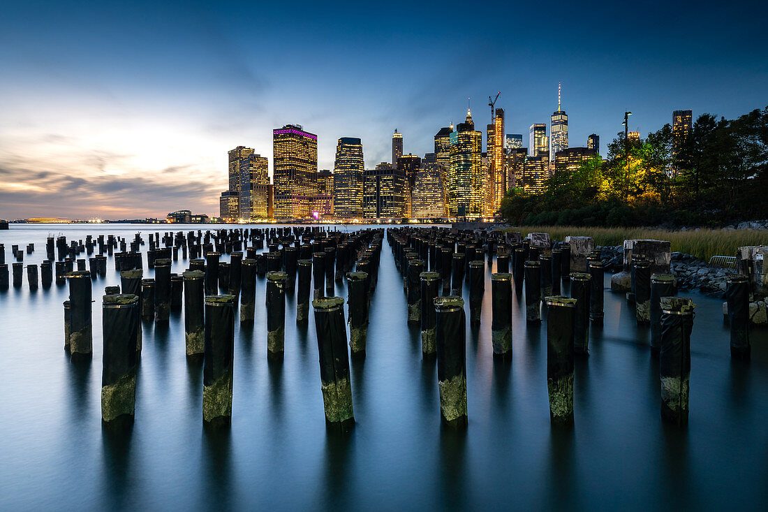 Long exposure of the lights of Lower Manhattan during the evening blue hour as seen from Brooklyn Bridge Park, New York, United States of America, North America