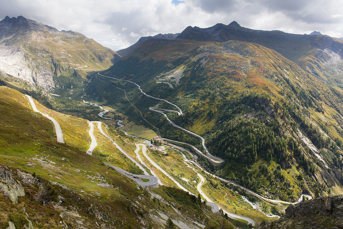 Twisting roads of the Furka and Grimsel Alpine Passes meet at the hamlet of Gletsch, Canton of Valais, Switzerland, Europe
