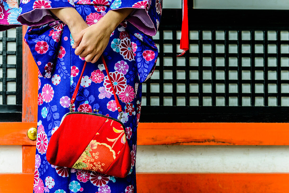 Close up of woman in kimono holding purse, Kyoto, Japan