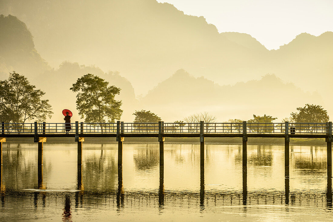 Mountains and bridge reflected in still lake, Hpa an, Kayin, Myanmar