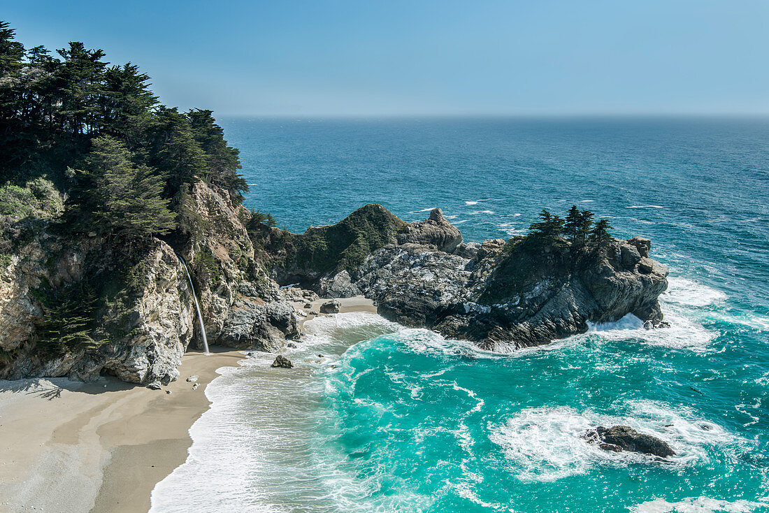 Aerial view of waves washing up on rocky beach, USA