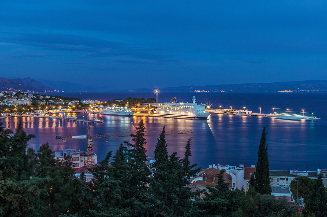 Aerial view of illuminated dock and cityscape of coastal town, Split, Split, Croatia