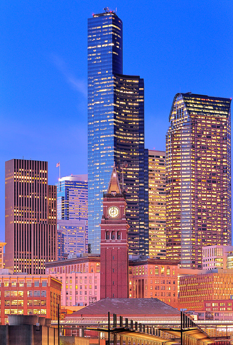Clock tower and illuminated high rise buildings in Seattle city skyline, Washington, USA