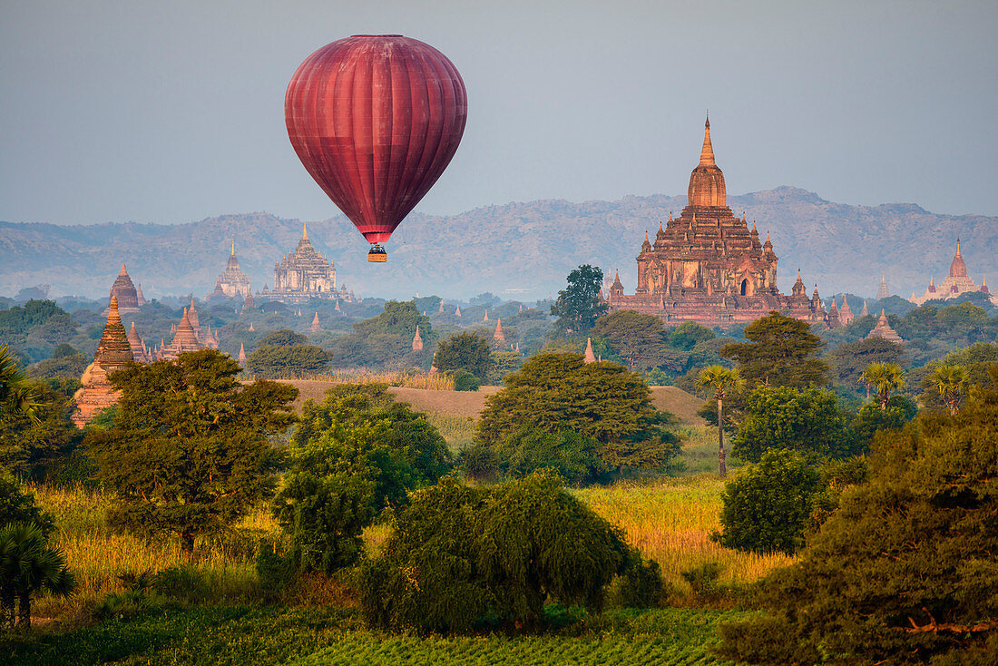 Hot air balloon flying over towers, Bagan, Myanmar