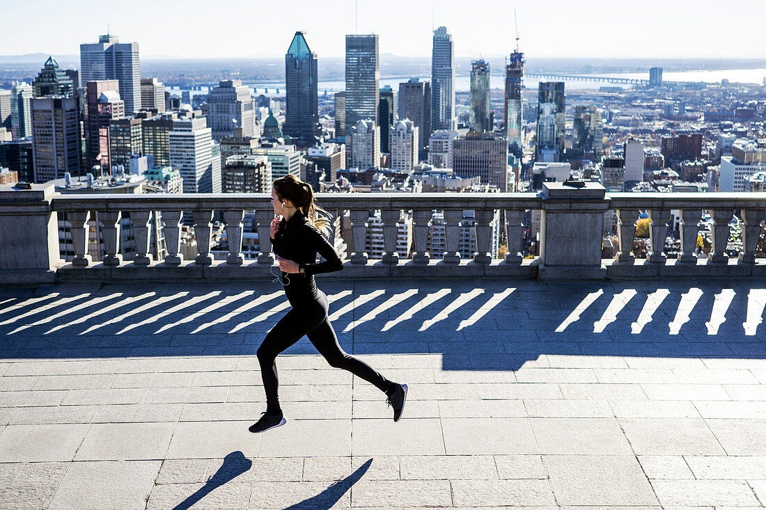 Caucasian woman running in city, Montreal, Quebec, Canada