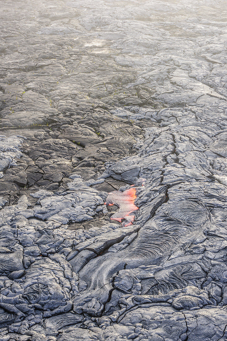 Molten lava glowing near dried lava, Big Island, Hawaii, USA