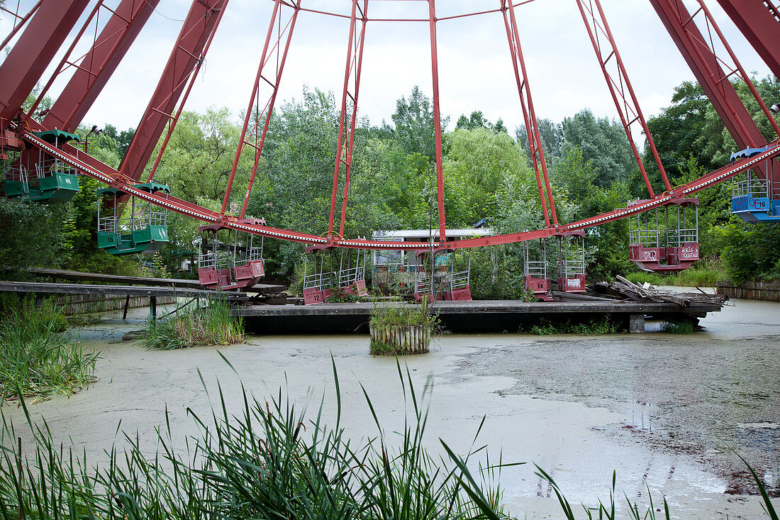 Overgrown ferris wheel in the disused amusement park in the Plänterwald, Treptow, Berlin, Germany