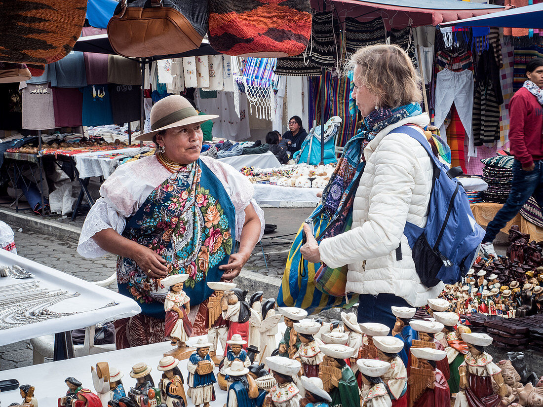 Tourist shopping at market, Plaza de los Ponchos, Otavalo, Ecuador, South America