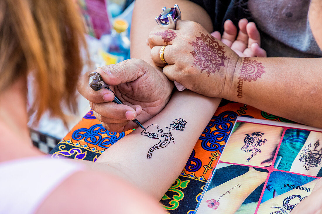 A henna tattoo being applied at the famous Walking Street night market in Phuket old Town, Phuket, Thailand, Southeast Asia, Asia
