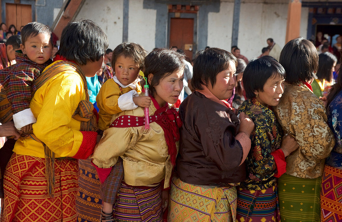 Women stand for blessing serpent, mask dance, festival at Gangteng Monastery, Phobjikha Valley, Bhutan, Himalayas, Asia