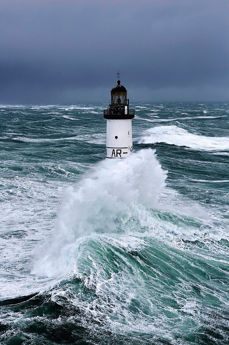 France, Finistere, Iroise Sea, Iles du Ponant, Parc Naturel Regional d'Armorique (Armorica Regional Natural Park), Ile de Sein, Chaussee de Sein, Ar Men Lighthouse during storm Ruth, February 8th 2014 (aerial view)