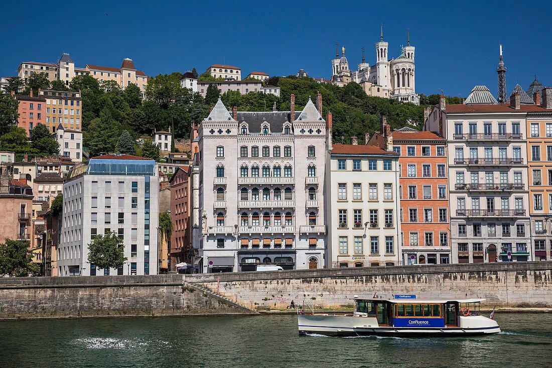 France, Rhone, Lyon, historical site listed as World Heritage by UNESCO, istrict of Vieux-Lyon, the river shuttle Vaporetto on Saone River and Notre Dame de Fourviere Basilica