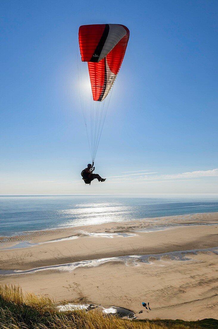 France, Manche, Barneville Carteret, a paraglider takes off from Cape Carteret and fly over the Old Church beach