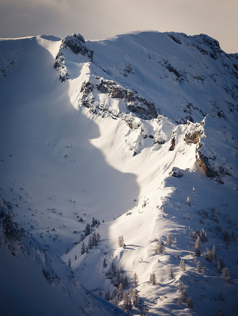 Tief verschneiter Bergrücken im Morgenlicht, abgegrenzt durch dunkele Schatten, Stanser Joch, Pertisau, Tirol, Österreich