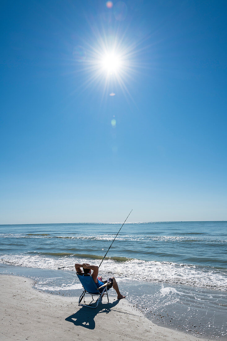 Relaxed beach fishing on the Gulf of Mexico, Fort Myers Beach, Florida, USA