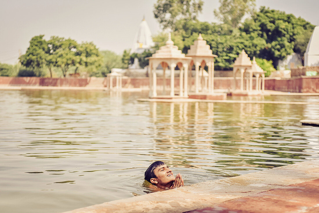 2017, Pavan Sarovar Nandgoan / Nandagram, Vrindavan, Uttar Pradesh, India, The Brahmin Krishna Murari Goswami having a bath in the holy seaside resort Pavan Sarovar in the place of residence Krishna