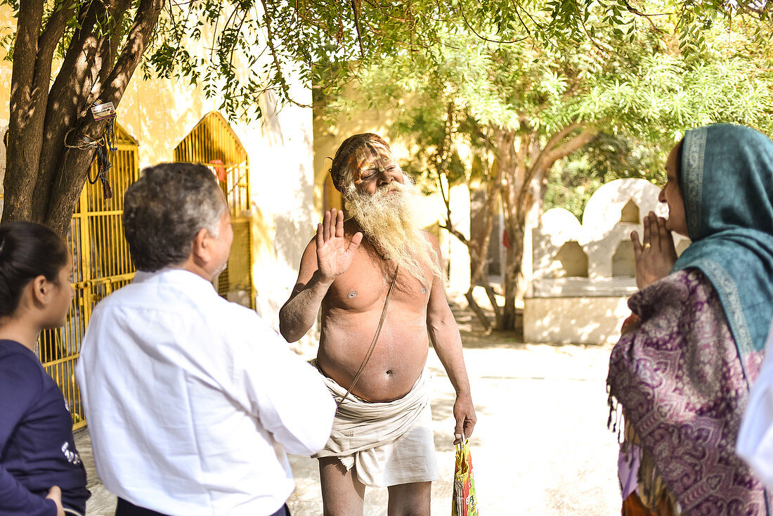 2019, Ter Kadamba, Govardhan, Vrindavan, Uttar Pradesh, India, Shiva Temple Asheshvara Mahadeva, holy man in the temple blesses family