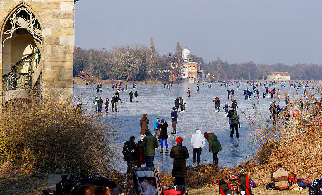 Winter fun on the Holy Lake, Gothic library and view to the Marble Palace, Potsdam, Brandenburg, Germany