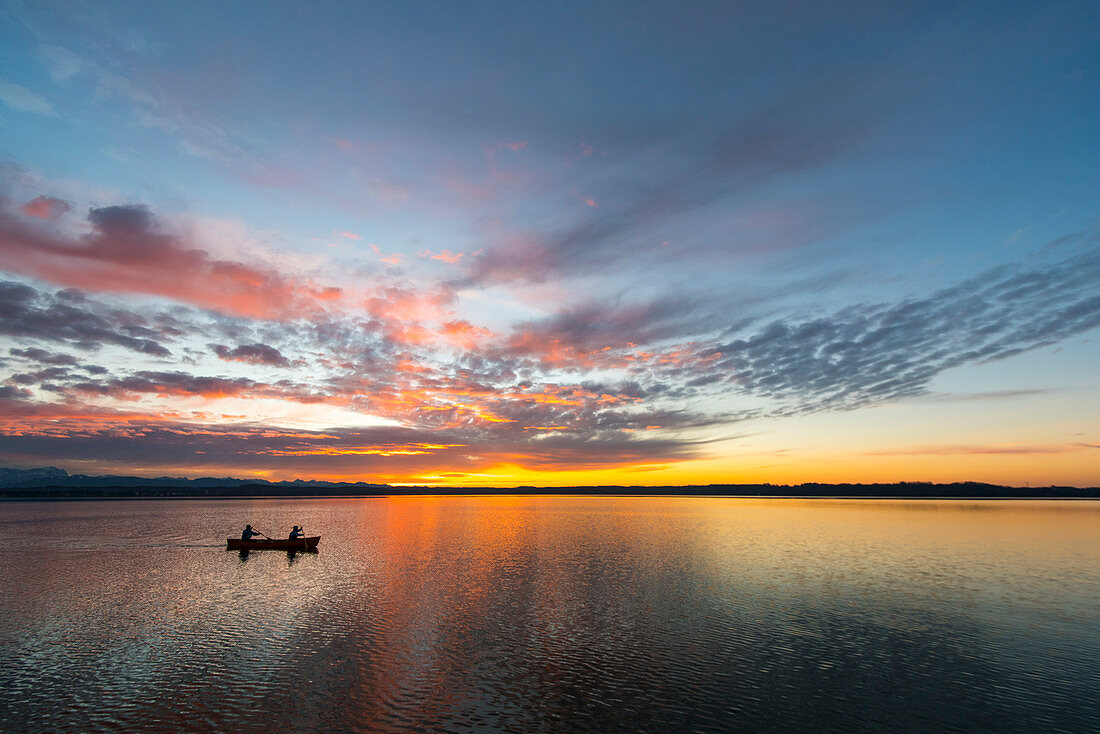 Evening canoe trip in Canadian on Lake Starnberg, Bavaria, Germany