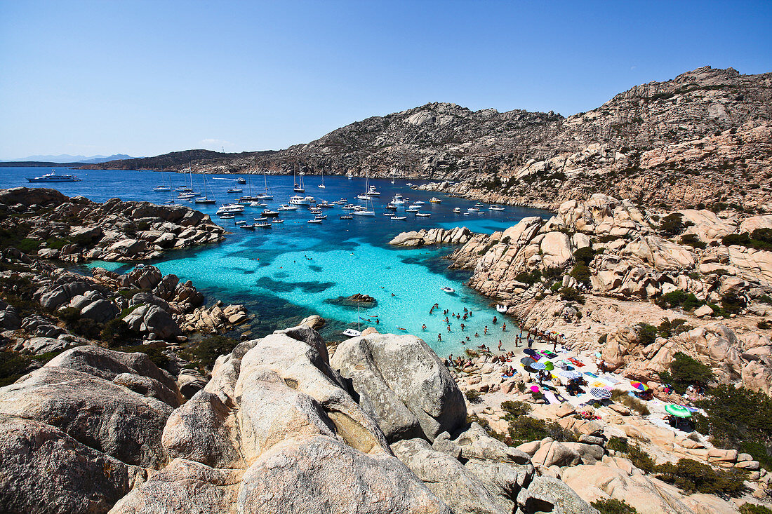 View of the ships and people bathing in the bay of the Isola di Maddalena, Sardinia, Italy, Europe