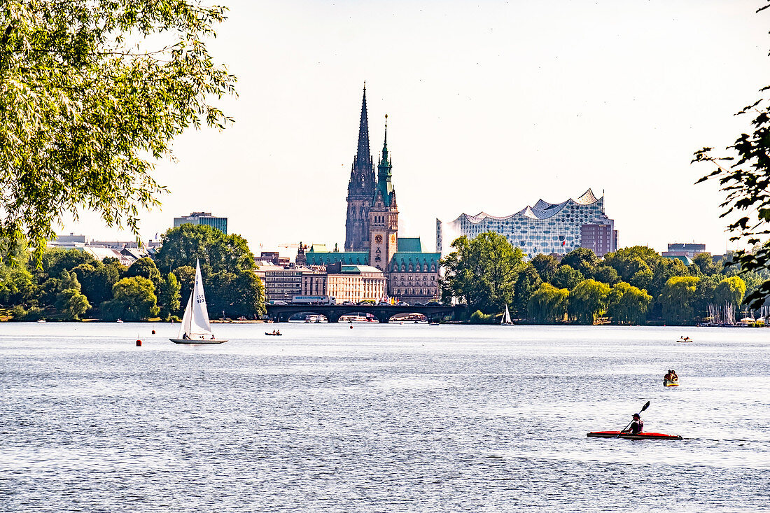 View over the Aussenalster to the town hall, the St. Nikolai memorial and the Elbphilharmonie in Hamburg, northern Germany, Germany