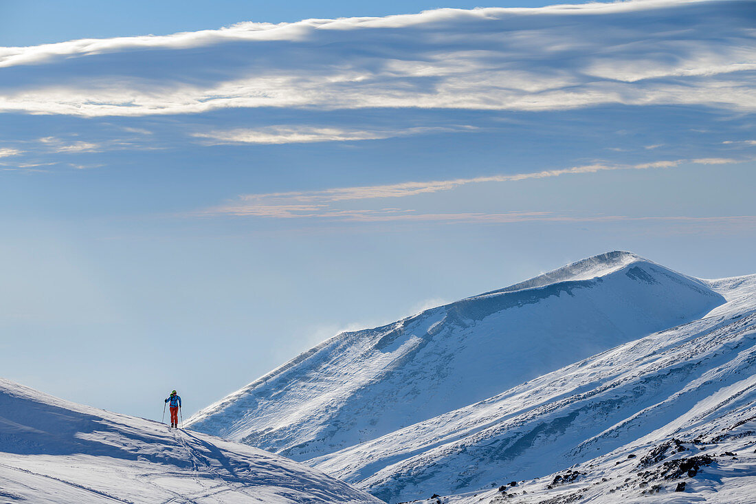 Frau auf Skitour steigt zum Ätna auf, Vulkankrater im Hintergrund, UNESCO Welterbe Monte Etna, Ätna, Sizilien, Italien