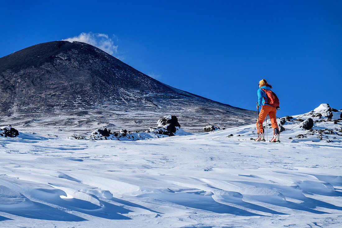 Woman on ski tour climbs to Mount Etna, UNESCO World Heritage Site, Monte Etna, Etna, Etna, Sicily, Italy