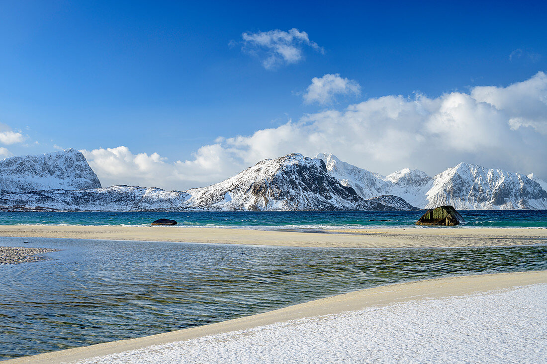 Sandy beach with snowy mountains in the background, Lofoten, Nordland, Norway