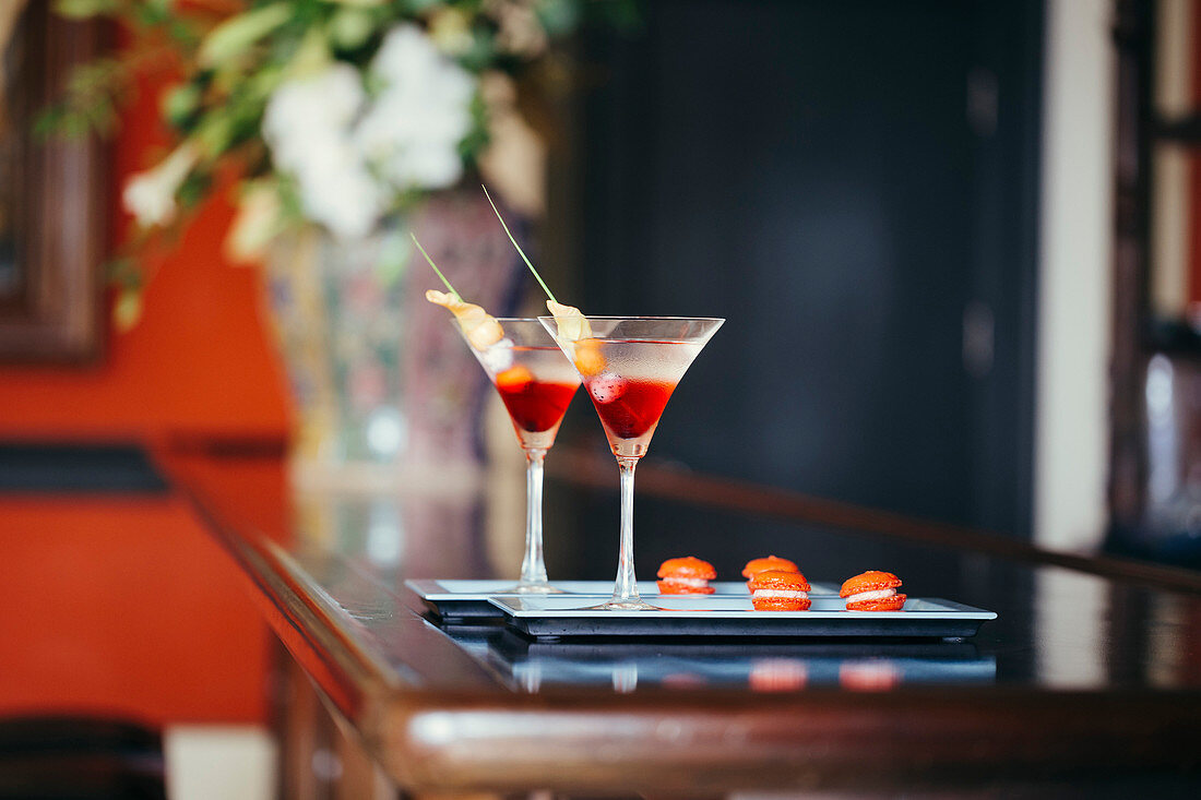 Close up of two cocktails on a tray.