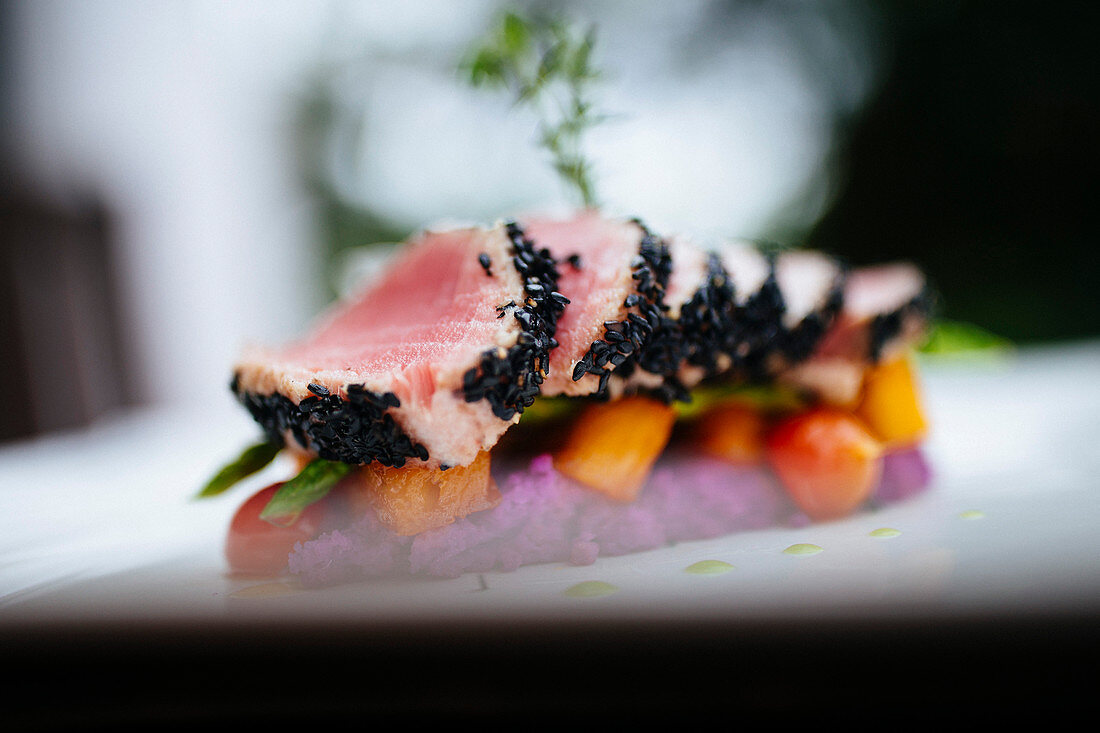 Close up of sesame crusted tuna on a plate.