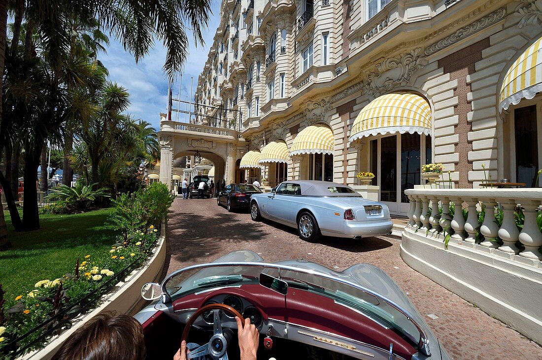 France, Alpes Maritimes, Cannes, the Carlton palace on the boulevard de la Croisette, aboard a collection convertible Porsche Speedster 356