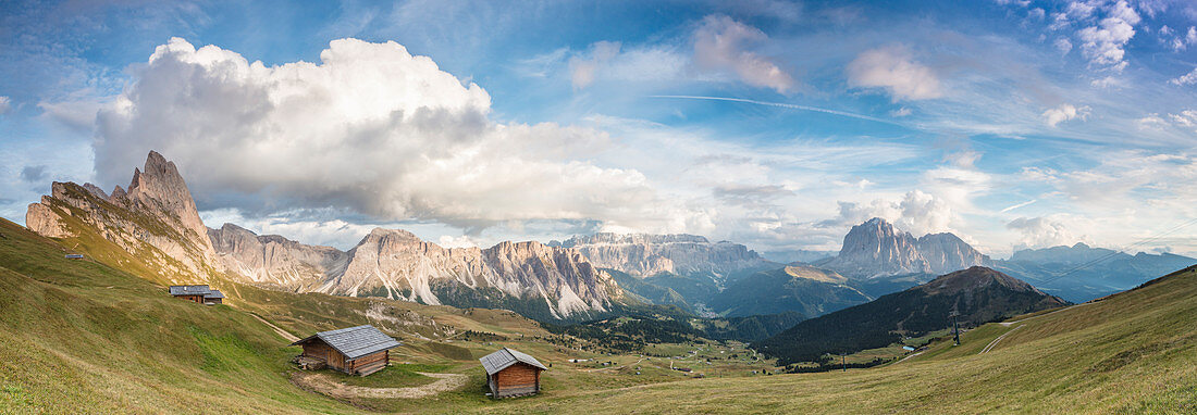 Panorama of green meadows and huts of the Odle mountain range seen from Seceda, Val Gardena, Trentino-Alto Adige, Italy, Europe