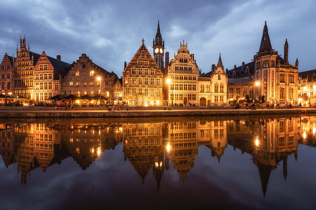 Graslei in the historic city of Ghent reflected in Leie river during blue hour, Ghent, East Flanders, Belgium, Europe