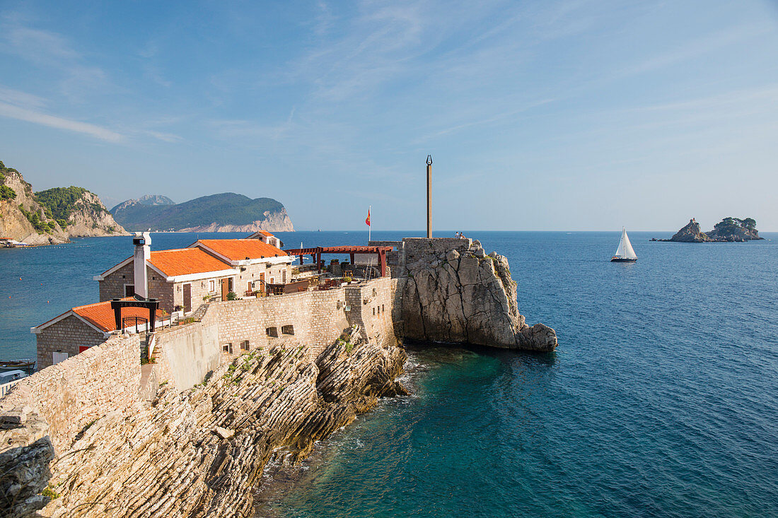 View along cliffs to 16th century Venetian fortress overlooking the Adriatic Sea, Petrovac, Budva, Montenegro, Europe