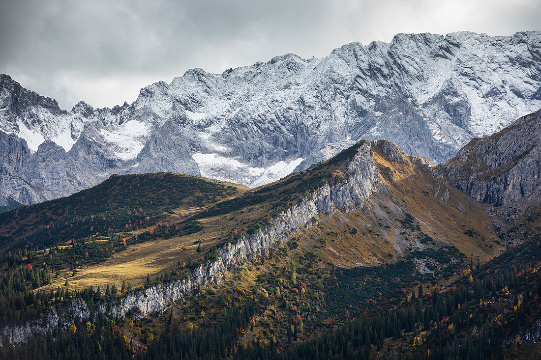 View from the Kreuzeck into the Reintal and snow-covered mountains near Garmisch-Partenkirchen in autumn, Bavaria
