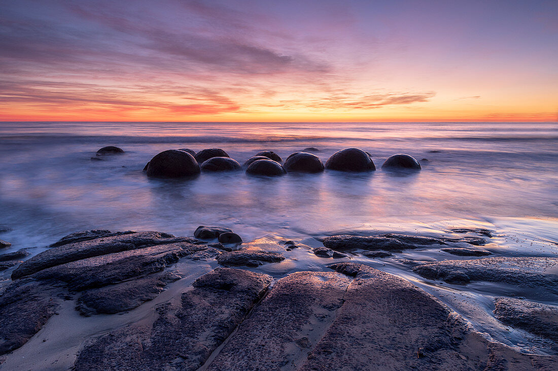 The Moeraki Boulders with incredible sunrise, Moeraki Beach, Otago, South Island, New Zealand, Pacific