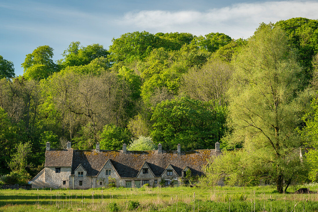 Arlington Row cottages in the pretty Cotswolds village of Bibury, Gloucestershire, England, United Kingdom, Europe