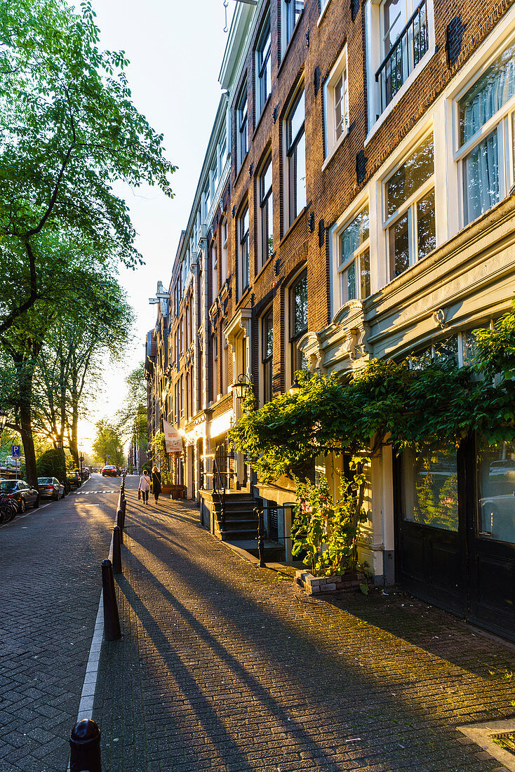 Golden hour light on canalside buildings, Amsterdam, North Holland, The Netherlands, Europe