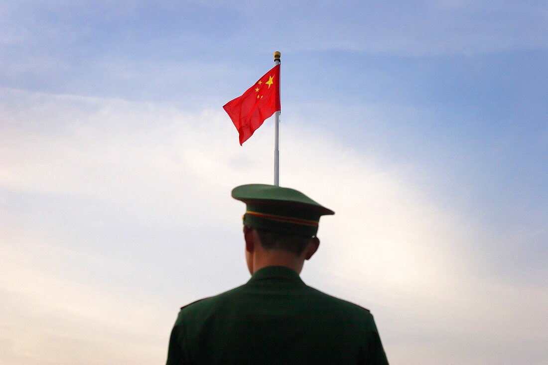 Military police prepare to lower the national flag in Tiananmen Square, Beijing, China, Asia