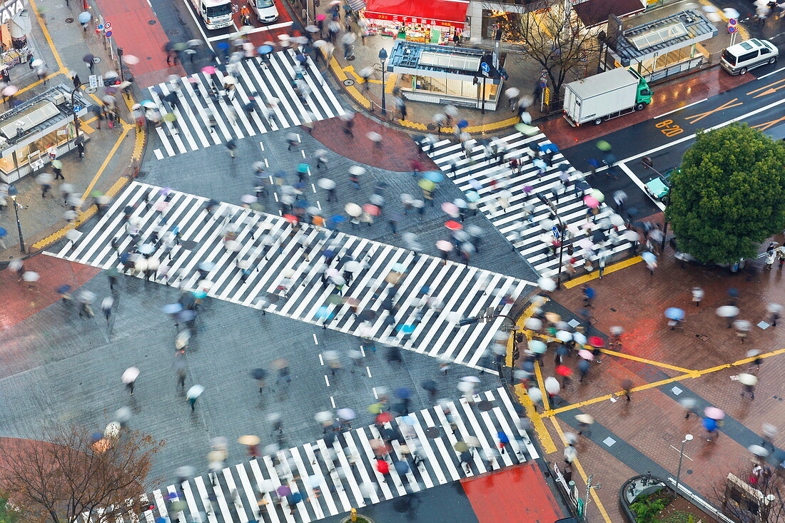 Aerial view of crowds crossing the famous Shibuya Crossing crosswalks at the centre of Shibuya's fashionable shopping and entertainment district, Shibuya, Tokyo, Japan, Asia