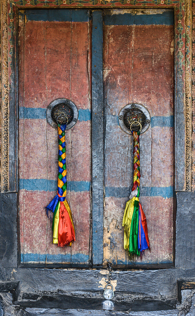 Intricate decorations on a doorway at Thiksey monastery (gompa), Ladakh, Himalayas, India, Asia