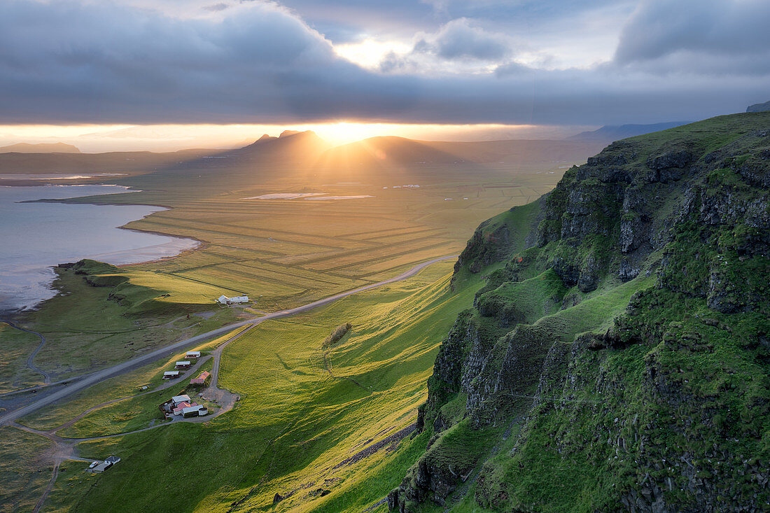 Viewpoint of Reynisfjara and Dyrholaey looking northwest in Iceland during a storm at golden hour, Iceland, Polar Regions