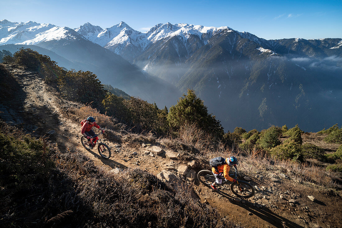 Mountain biking along a Enduro style single track trail in the Nepal Himalayas near the Langtang region, Nepal, Asia